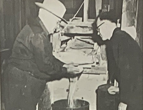 Warden inspecting grain - 1940s